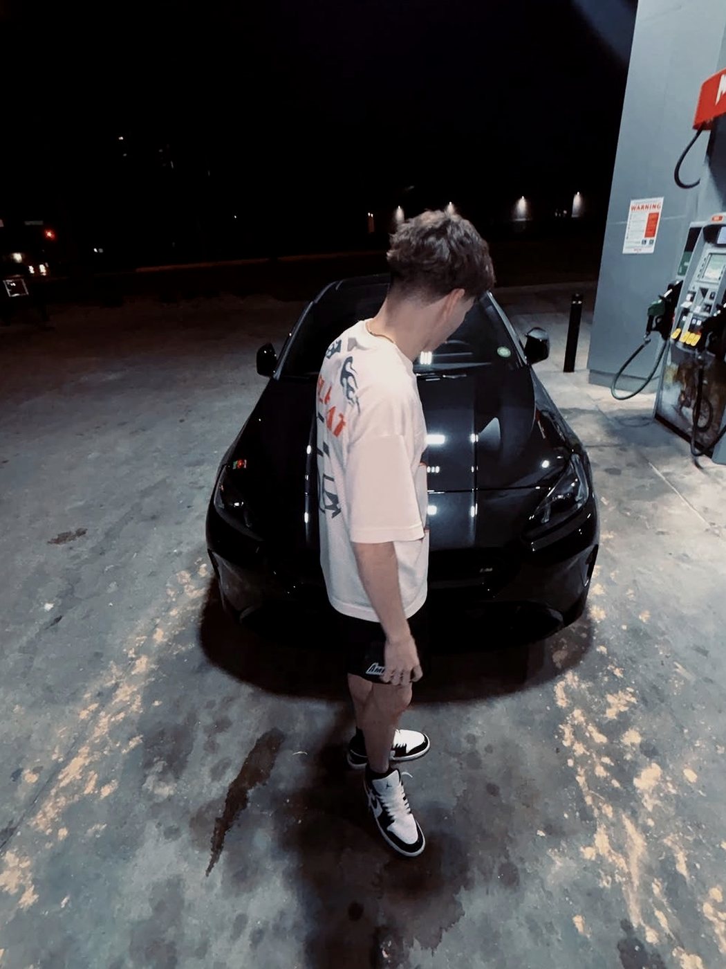 Travis standing in front of his black 2026 BMW at night